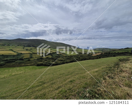 Mountain Landscape with Grass and Clouds in the Sky Mountain Landscape with Grass and Clouds in the Sky 125184311