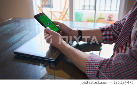 Young Professional Planning A Startup Using A Smartphone and Laptop 125184475
