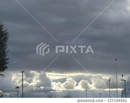 White cumulus clouds in the stormy sky 125184882