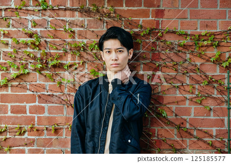A young man in his 20s in plain clothes 125185577
