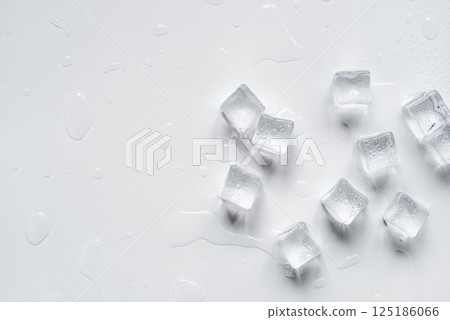 Melting ice cubes in a splash of water on a white background Melting ice cubes in a splash of water on a white background 125186066