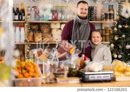 Man and boy shopping in grocery store Man and boy shopping in grocery store 125186263