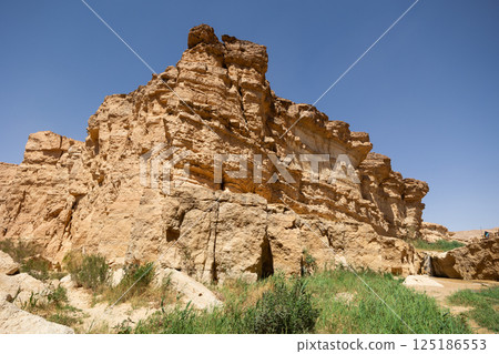 Waterfall cascading through desert canyon in Tamaqzah, Tunisia Waterfall cascading through desert canyon in Tamaqzah, Tunisia 125186553