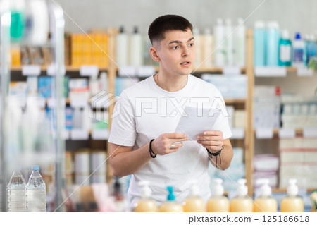 guy with a medical defect in a pharmacy 125186618