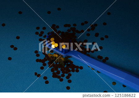 Toothbrush with sparkles on a dark blue background, concepts of dentistry and hygiene. Oral health. 125186622