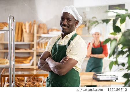 African man seller stands in trading hall of bakery 125186740