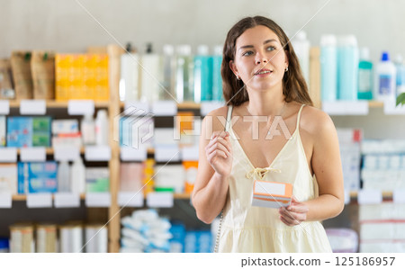 Girl buys pills at pharmacy 125186957