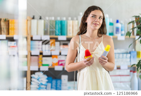 Woman choosing a repellent at the pharmacy Woman choosing a repellent at the pharmacy 125186966