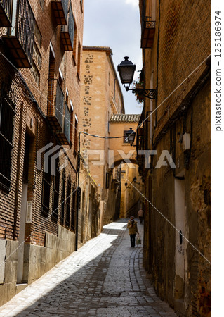 Old Toledo cityscape with typical narrow cobblestone streets Old Toledo cityscape with typical narrow cobblestone streets 125186974
