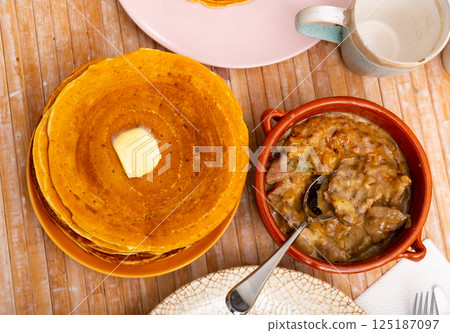Pancakes with meat and vegetables stew machanka 125187097