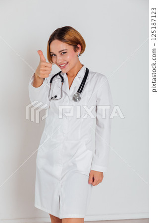 Woman Doctor With Stethoscope In Hospital Showing Hand Thumbs Up 125187123