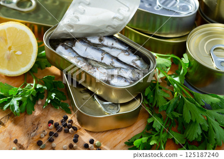 Tin can with smoked sprats, sardines, closeup 125187240