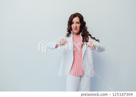 woman getting angry and clenching her fists on a white background woman getting angry and clenching her fists on a white background 125187304