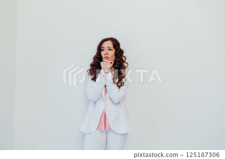 woman pondering on white office background 125187306