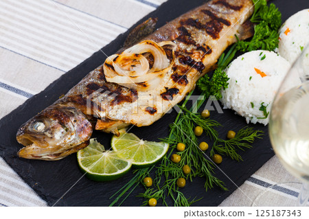 Grilled trout with rice 125187343