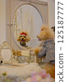 Toy poodle looking in the mirror 125187777