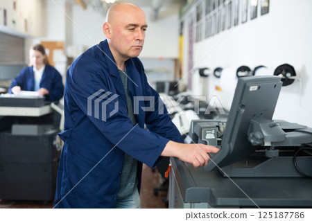 Man working in publishing facility 125187786