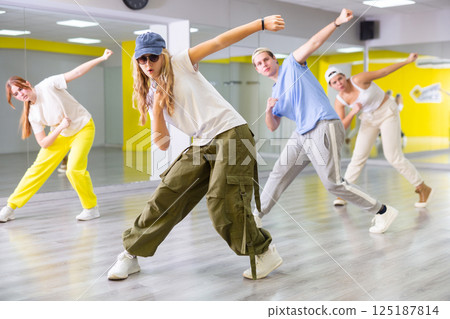 Teen girl in cap dancing modern dances Teen girl in cap dancing modern dances 125187814