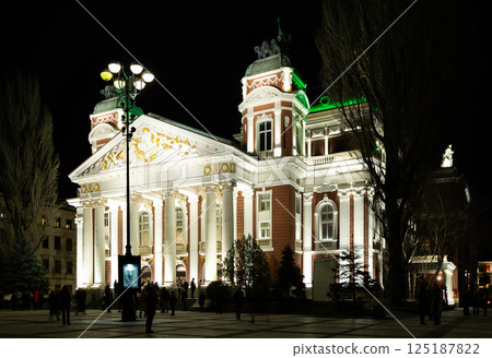 National Theatre Ivan Vazov building is brightly illuminated and stands out against evening sky National Theatre Ivan Vazov building is brightly illuminated and stands out against evening sky 125187822