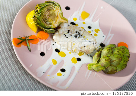 Deliciously fillet of fried horse-mackerel with sauce and artichokes Deliciously fillet of fried horse-mackerel with sauce and artichokes 125187830
