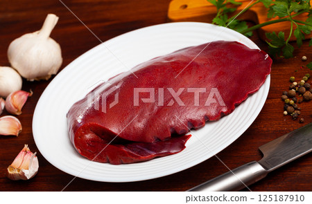 Cooking pork liver with parsley and garlic on the table 125187910