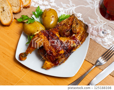 Grilled chicken piece and potatoes served in a plate 125188108