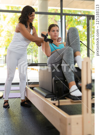 Positive activ hispanic female trainer controlling sports woman 125188113