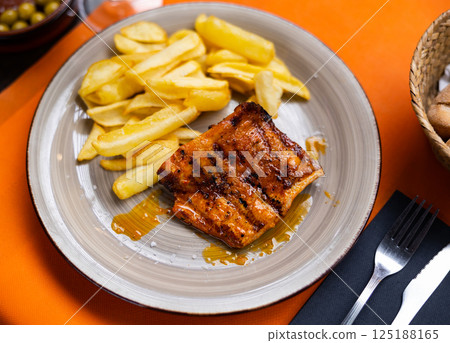 Pork secret served with potatoes on platter 125188165