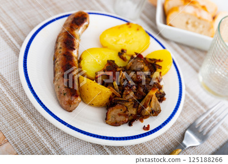 Popular dish made from sausages with mushrooms and potatoes 125188266
