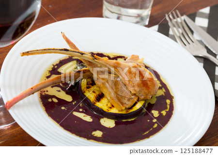 Baked lamb ribs with eggplant in wine sauce Baked lamb ribs with eggplant in wine sauce 125188477