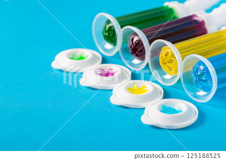 Set of multi-colored gel syringes with disinfectant and cleaner for cleaning the toilet bowl on a blue background, hygiene, close-up. Copy space for text Set of multi-colored gel syringes with disinfectant and cleaner for cleaning the toilet bowl on a blue background, hygiene, close-up. Copy space for text 125188525