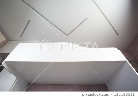 White two-story bed against the background of a ceiling with LED strip in the bedroom 125188531