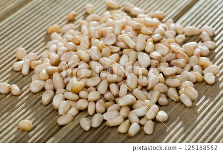 Picture of wooden desk with raw pine nut, nobody Picture of wooden desk with raw pine nut, nobody 125188552