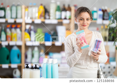 Young woman choosing razor in store Young woman choosing razor in store 125188698