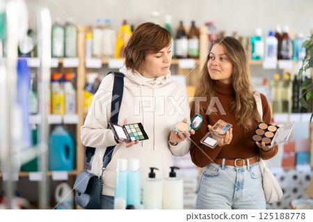 Store visitor women purchases in household chemicals department, choose eye shadow pallet 125188778