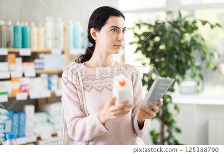 Young woman chooses cream at pharmacy 125188790