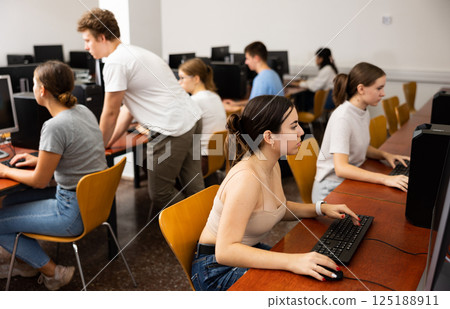Portrait of interested teen girl during lesson in computer room of school class 125188911