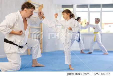 Father and daughter training karate fighting techniques Father and daughter training karate fighting techniques 125188986