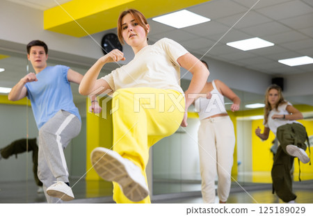 Young girl training breakdance Footwork moves in dance hall 125189029