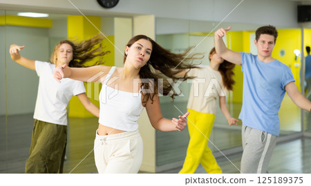 Young girl training breakdance Toprock moves in dance hall 125189375