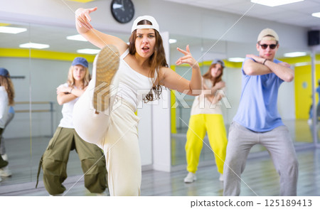 Young girl in cap dancing hip hop Young girl in cap dancing hip hop 125189413