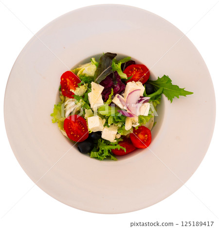 Plate of colorful salad of fresh greens, vegetables and cheese Plate of colorful salad of fresh greens, vegetables and cheese 125189417