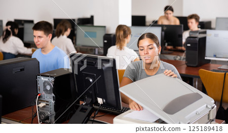 Young woman using scanner in computer class Young woman using scanner in computer class 125189418