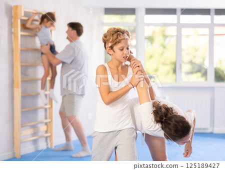 Parents and children during training and self-defense workout. 125189427