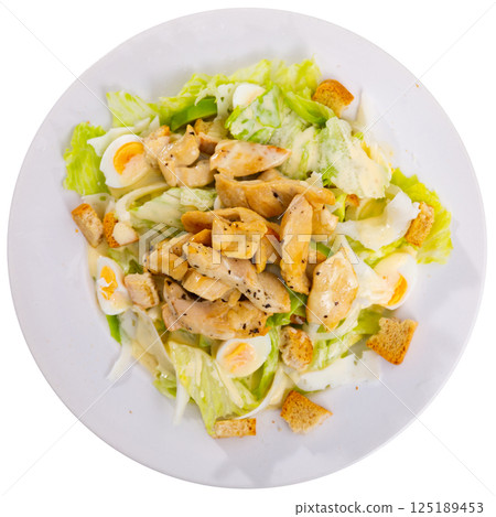Caesar salad with sawn eggs on a plate on a gray background 125189453
