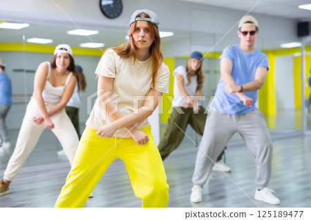 Teen girl in cap dances hip hop dances 125189477
