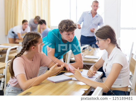 Fellow students having group work tasks during school 125189481