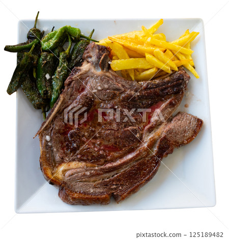 Grilled beef garnished with French fries and baked green pepper. 125189482
