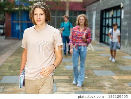 Teenager boy going home after school 125189495