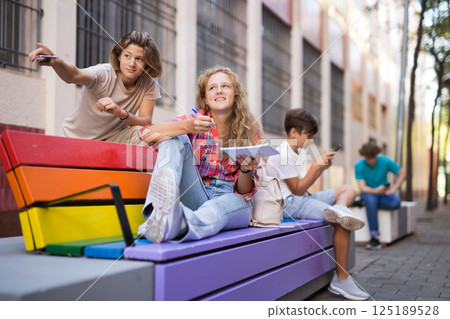 Guy and girl have fun chatting. Guy points his hand at someone Guy and girl have fun chatting. Guy points his hand at someone 125189528